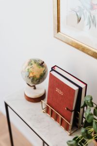 Kaboompics - Planner on The White Marble Table, White Background, Pilea, Globe, Painting on the Wall