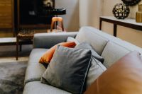 Kaboompics - Grey and orange pillows on a sofa