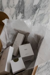 Kaboompics - Unboxing Beauty Products in a UGC Aesthetic: Elegant Skincare Packaging with Textured Wrapping