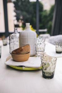 Glasses and jars on a white garden table