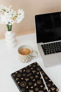 Kaboompics - Laptop - white flowers - organizer - pen & cup of coffee on marble table
