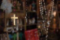 Kaboompics - Ornate Silver Cross Pendant Hanging in a Religious Store Display