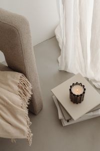 Kaboompics - Home decorations - beige armchair - candles - book - blanket