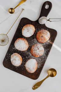 Homemade doughnuts covered with powdered sugar. Traditional speciality on Fat Thursday in Poland.