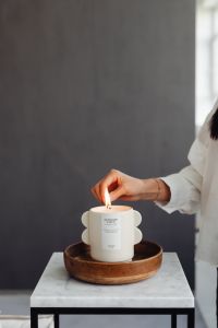 A woman lights a candle