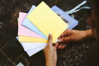 Kaboompics - Woman holding colourful envelopes