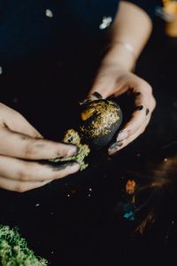 Kaboompics - Woman Painting Black & Gold Easter Eggs