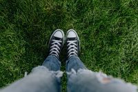 Woman, jeans, sneakers, green grass