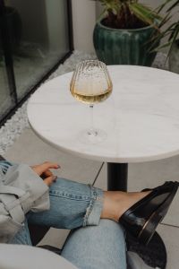 Kaboompics - White Marble Table with a Glass of White Wine and Stylish Sunglasses - Metal Chair