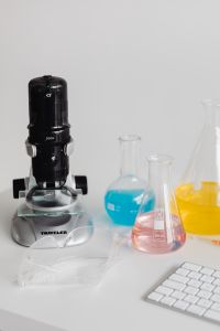 Microscope - keyboard - computer - desk - laboratory glassware