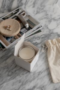 Kaboompics - Elegant Aromatic Candle Unboxing on Marble Tabletop - UGC Style Interior Design