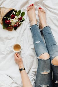 Kaboompics - Woman with coffee and flowers in bed