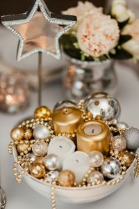 Christmas decorations and candles in gold and silver tones