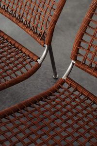 Close-up of rattan-woven seats with metal frames in a stylish pattern