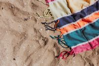 Kaboompics - Colorful beach towel on the sand