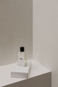 Kaboompics - Stylish UGC-Influenced Perfume Bottle on White Surface with Textured Background - Chic Free Stock Photo