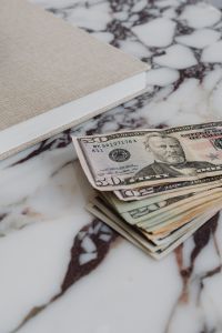 Dollar bills on a marble table