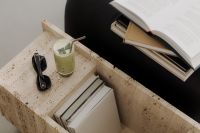 Matcha Latte on Travertine Table Next to Black Leather Sofa - Japandi Style