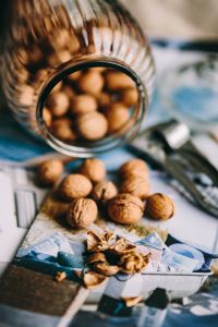 Kaboompics - Glass jar full of walnuts and a nutcracker