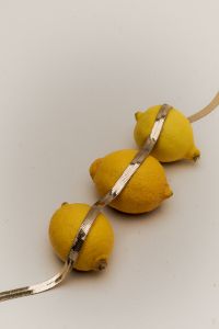 Kaboompics - Lemons Draped in Gold Necklace – Luxurious Citrus Photography