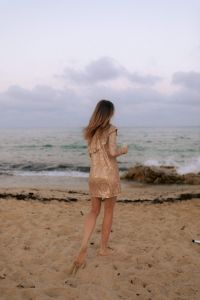 Kaboompics - Muted Tones & Golden Hour Hues - Women Celebrating by the Sea with Champagne