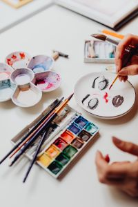 A woman paints with watercolors