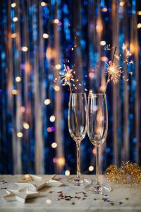 New Year's Eve - cold fires in glasses on a blue background