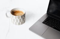 Kaboompics - Cup of coffee & Macbook laptop on white marble