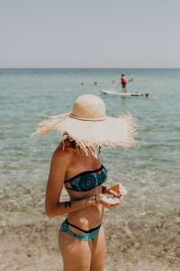 The woman in the beach hat made of raffia