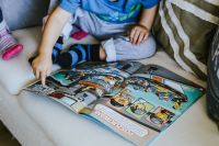 Kaboompics - Child reading a comic story