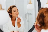 Skincare routine - Middle-Aged Woman in Bathroom