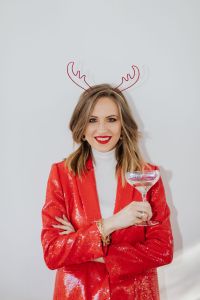 Kaboompics - Woman in a red jacket holds a glass