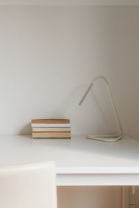 Kaboompics - Minimalist Desk Setup with Books and Modern Lamp