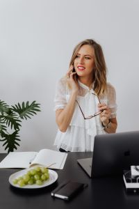 Kaboompics - A businesswoman speaks on the phone at her desk