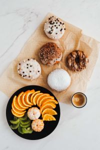 Kaboompics - Donuts, coffee & plate with fruits: orange, madarine, kiwi
