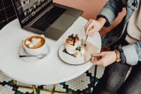 Kaboompics - Working with a laptop, meringue with whipped cream and coffee on white marble