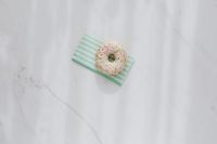 Donuts on paper napkins placed on white marble