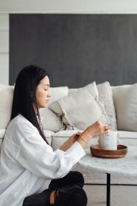 Kaboompics - An Asian adult woman lights a candle
