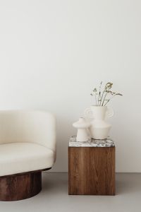 Kaboompics - Wooden side table with marble top - bright ceramic vases - upholstered armchair