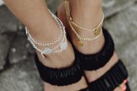 Feet in sandals with gold and silver jewelry