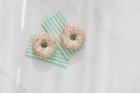 Donuts on paper napkins placed on white marble