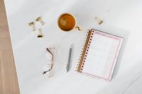 Kaboompics - Top view of a marble desk with coffee, notebooks and pen