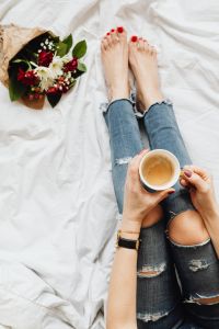 Kaboompics - Woman with coffee and flowers in bed