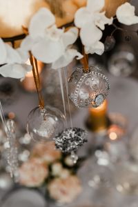 Silver decorations hanging over the Christmas table