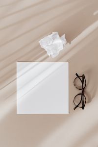 Kaboompics - Blank card & glasses on beige background