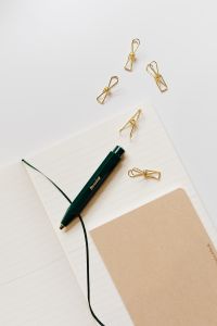 Kaboompics - Pen, clips and notebooks on a white desk