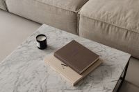 Living room - gray beige sofa - marble coffee table - coffee table books - candle