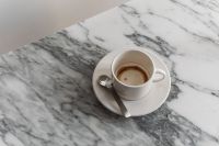 Kaboompics - Arabescato Marble Table - Cup of Coffee - Metal Spoon