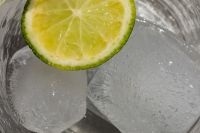 Glass with water - lime - ice cubes - closeup - close-up - close up