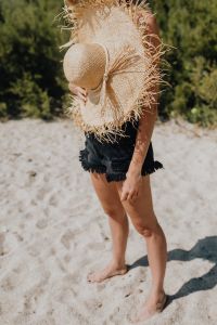 Beautiful woman with sunglasses and a summer straw hat